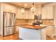 Modern kitchen with stainless steel appliances, wood floors and countertop island and pendant lighting at 1012 Equipoise Dr, Indian Trail, NC 28079