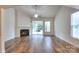 Inviting living room featuring a cozy fireplace, hardwood floors, and sliding doors that lead to the outdoor space at 1012 Equipoise Dr, Indian Trail, NC 28079