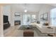 Bright living room featuring a fireplace, neutral decor, vaulted ceilings, and abundant natural light at 1012 Equipoise Dr, Indian Trail, NC 28079