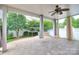 Covered patio with ceiling fan and views of the landscaped backyard and lawn at 1012 Equipoise Dr, Indian Trail, NC 28079