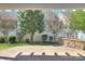 Covered patio featuring stone detailing and lush trees at 1012 Equipoise Dr, Indian Trail, NC 28079