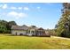 Expansive backyard with a well-manicured lawn, screened porch, and ample space for outdoor recreation at 1131 Doby Ct, Fort Mill, SC 29715