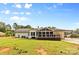 Spacious backyard featuring a well-maintained lawn, screened porch, and carport, perfect for outdoor activities at 1131 Doby Ct, Fort Mill, SC 29715
