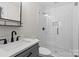 Modern bathroom features a sleek vanity with black hardware and a stylish subway-tiled shower with glass door at 1131 Doby Ct, Fort Mill, SC 29715