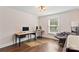 Bright bedroom features hardwood floors, natural light, and a modern desk setup for a comfortable workspace at 1131 Doby Ct, Fort Mill, SC 29715