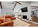 Inviting living room with exposed beams, brick fireplace and a comfortable leather sofa at 1131 Doby Ct, Fort Mill, SC 29715