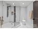 Modern bathroom with a soaking tub, glass enclosed shower with rainfall shower head and stylish fixtures at 1131 Doby Ct, Fort Mill, SC 29715