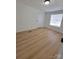 Bedroom with wood-look flooring and natural light from the window at 1170 Meadowcreek Dr, China Grove, NC 28023