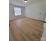 Bedroom with wood-look flooring, one closet, and natural light from the window at 1170 Meadowcreek Dr, China Grove, NC 28023
