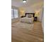 Cozy bedroom with wood-look flooring, a fluffy rug, and soft, neutral bedding at 1170 Meadowcreek Dr, China Grove, NC 28023