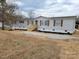Inviting single-story home with fresh landscaping, a light-colored facade, and newly built front steps at 1170 Meadowcreek Dr, China Grove, NC 28023