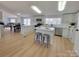Bright, open kitchen with white cabinetry, stainless steel appliances, and a center island with barstool seating at 1170 Meadowcreek Dr, China Grove, NC 28023