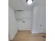 Laundry room featuring wood-look flooring, overhead cabinets and shelving at 1170 Meadowcreek Dr, China Grove, NC 28023