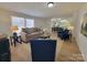 Bright living area with modern decor, plush seating, and an open view to the dining and kitchen spaces at 1170 Meadowcreek Dr, China Grove, NC 28023
