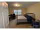Neutral bedroom featuring a bed, desk and natural light at 128 Cromer St, Charlotte, NC 28208