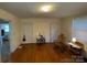 Bedroom with hardwood floors, two closets, and a rocking chair at 128 Cromer St, Charlotte, NC 28208