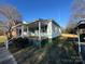View of the house showcasing its side profile, porch, and surroundings at 128 Cromer St, Charlotte, NC 28208