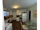 Functional kitchen with white cabinets, modern appliances, and a cozy dining area at 128 Cromer St, Charlotte, NC 28208