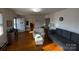 Cozy living room featuring hardwood floors, a neutral sofa, and ample natural light at 128 Cromer St, Charlotte, NC 28208