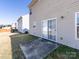 View of the backyard featuring a small patio and sliding door access at 12915 Deaton Hill Dr, Charlotte, NC 28269