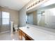 Bathroom with a vanity, a large mirror with lights, and a view of the shower at 12915 Deaton Hill Dr, Charlotte, NC 28269