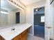 Bathroom with a large mirror, vanity, and a view of the doorway to the next room at 12915 Deaton Hill Dr, Charlotte, NC 28269