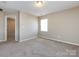 Spacious bedroom with neutral carpet, natural light, and a ceiling light at 12915 Deaton Hill Dr, Charlotte, NC 28269