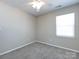 Bedroom featuring neutral carpet, a large window, and a ceiling fan at 12915 Deaton Hill Dr, Charlotte, NC 28269