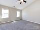Bedroom features two windows offering natural light and neutral carpet and walls at 12915 Deaton Hill Dr, Charlotte, NC 28269