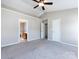 Spacious bedroom with neutral carpet, a ceiling fan, and two closets at 12915 Deaton Hill Dr, Charlotte, NC 28269