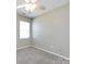 Bedroom featuring neutral carpet, a large window, and bright white walls at 12915 Deaton Hill Dr, Charlotte, NC 28269