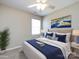 Bright bedroom with neutral carpet, a bed, blue accents, and a ceiling fan at 12915 Deaton Hill Dr, Charlotte, NC 28269