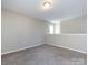 Spacious bonus room with neutral paint, carpet, and bright natural light at 12915 Deaton Hill Dr, Charlotte, NC 28269