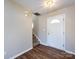 Bright entryway with hardwood floors, stairs, and a classic white front door at 12915 Deaton Hill Dr, Charlotte, NC 28269