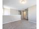 Second story hallway with neutral walls and carpet, connecting to other rooms at 12915 Deaton Hill Dr, Charlotte, NC 28269