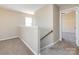 Upstairs hallway with neutral paint, carpet, and an open doorway to another room at 12915 Deaton Hill Dr, Charlotte, NC 28269