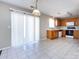 Open kitchen area featuring tiled flooring, wooden cabinets, and sliding door access at 12915 Deaton Hill Dr, Charlotte, NC 28269