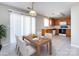 Eat-in kitchen with wooden cabinets, white appliances, and a dining table set for four at 12915 Deaton Hill Dr, Charlotte, NC 28269