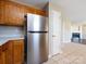 Kitchen view showing the stainless steel refrigerator, and an adjacent view into the living room at 12915 Deaton Hill Dr, Charlotte, NC 28269