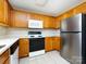 Well-equipped kitchen featuring white countertops and wood cabinets and stainless steel refrigerator at 12915 Deaton Hill Dr, Charlotte, NC 28269