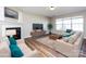 Cozy living room with a fireplace, plush seating, hardwood floors and natural light at 12915 Deaton Hill Dr, Charlotte, NC 28269