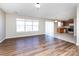 Open-concept area with hardwood flooring connecting the living space to the kitchen with tile flooring at 12915 Deaton Hill Dr, Charlotte, NC 28269