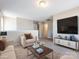 Bright living room with comfortable seating, stylish decor, and a mounted television at 12915 Deaton Hill Dr, Charlotte, NC 28269