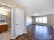 Open-concept space with hardwood floors, bathroom, and a well-lit living area with large windows at 12915 Deaton Hill Dr, Charlotte, NC 28269