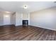 Spacious living room featuring a fireplace and dark hardwood floors for a modern look at 12915 Deaton Hill Dr, Charlotte, NC 28269