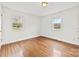 Bright, empty bedroom with hardwood floors and well-lit with lots of natural light at 1335 Blacksnake Rd, Stanley, NC 28164
