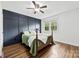 Charming bedroom with paneled accent wall, hardwood floors, and bright natural light at 1335 Blacksnake Rd, Stanley, NC 28164