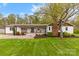 Charming ranch-style home with a cozy front porch and well-manicured lawn at 1335 Blacksnake Rd, Stanley, NC 28164