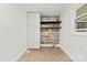 Efficient laundry area with shelving for storage and laundry sink at 1335 Blacksnake Rd, Stanley, NC 28164