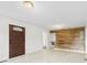 Large living room with tile flooring features a wood accent wall at 1335 Blacksnake Rd, Stanley, NC 28164